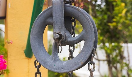 Large wheel with a chain arount it.