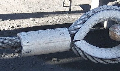 A concrete cylinder around steel cable to prevent fraying.