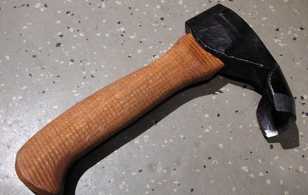 A short hand tool with an edge perpendicular to the handle.
